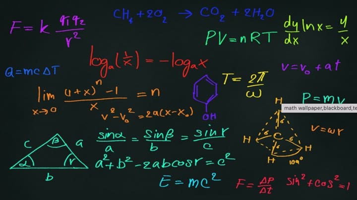 A chalkboard with many different equations written on it.