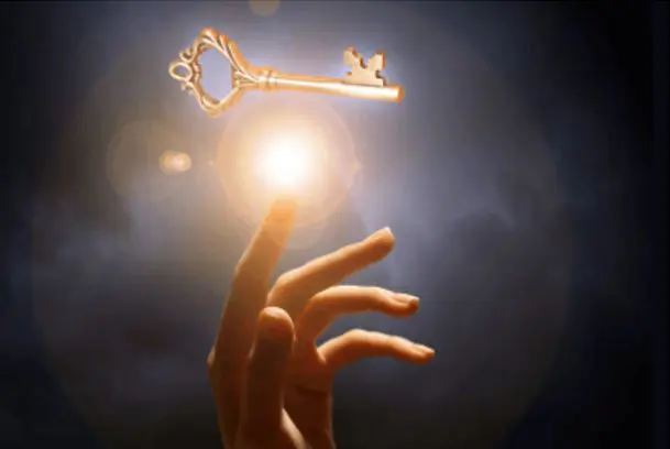 A hand is reaching for the key to go into the light.