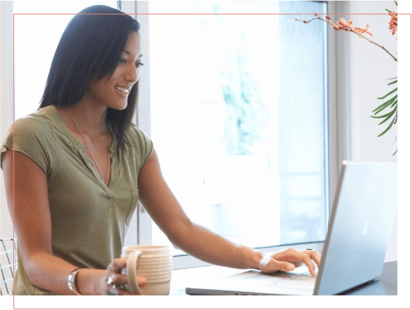 A woman sitting at a table with a laptop.